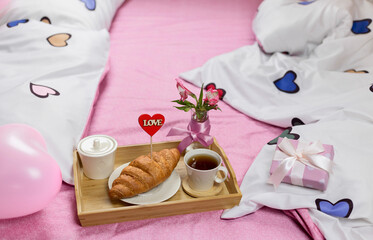 A romantic breakfast is served in bed. Selective focus.