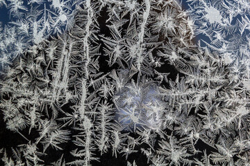 Melting ice running down a window pane,