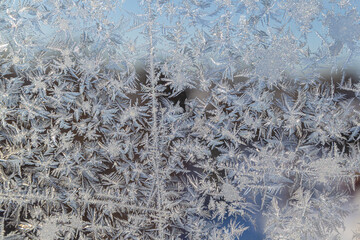 Melting ice running down a window pane,