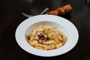 Pasta with mushrooms. Traditional Italian dish served on restaurant table.
