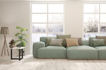 White living room with sofa and winter landscape in window. Scandinavian interior design. 3D illustration