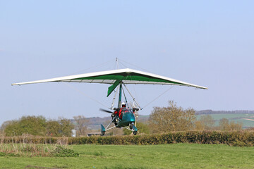 Ultralight airplane taking off from a farm strip	