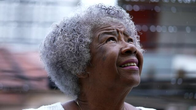 A Senior black woman looking up at sky face closeup