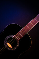 Obraz na płótnie Canvas black guitar front view vertical. guitar music low-key concept