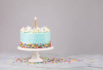 Blue Birthday Cake with sprinkles and Birthday Candle - 486116568