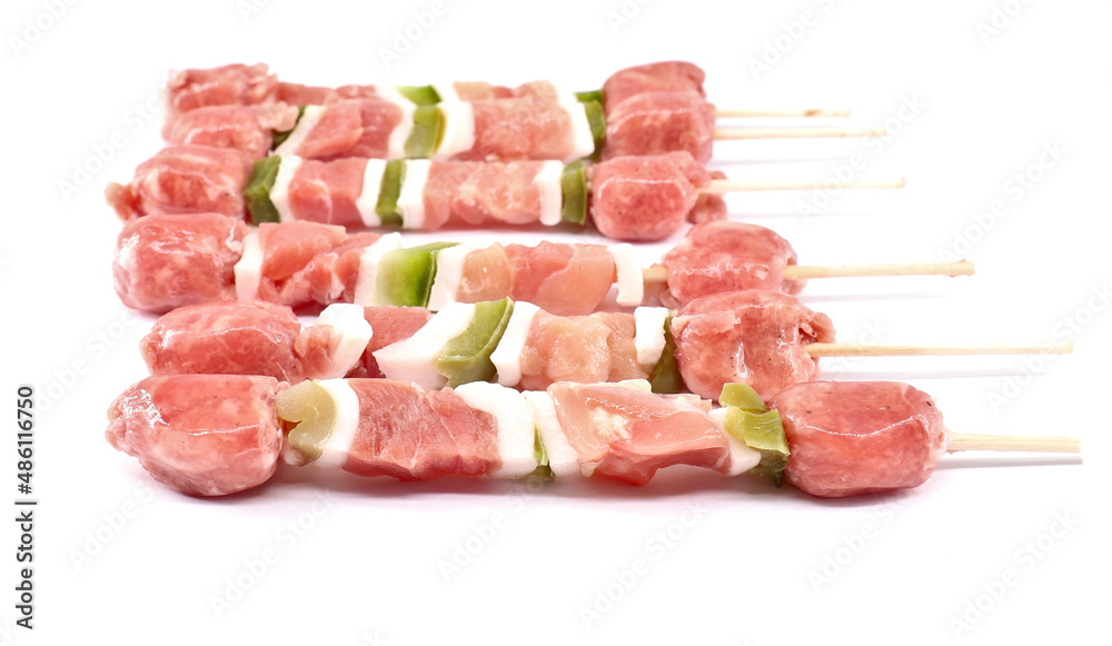 Wall mural Uncooked mixed meat skewer with peppers, ready to be grilled.  White background.