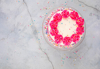 Birthday Cake with pink buttercream icing and sprinkles