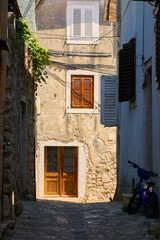 Fototapeta na wymiar historical for the region typical house in an alley in the old town of Krk in Croatia 