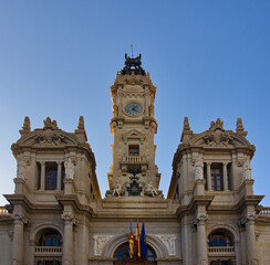 Fototapeta na wymiar Valencia City Hall clock tower with blue sky in the background