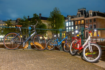 Cycling Family :) on the Canal Embankment in Amsterdam at Night