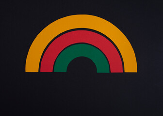 Black history month colors rainbow. Paper cut abstract composition on dark background.