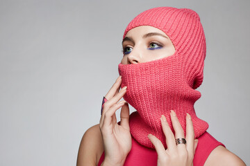 beautiful girl in red balaclava. Trendy Pink Mask on pretty woman
