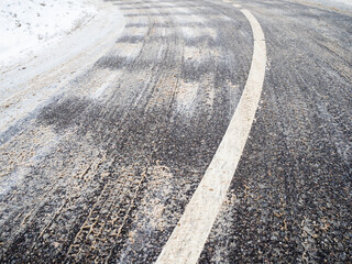 Fototapeta premium bend of iced slippery city road in winter