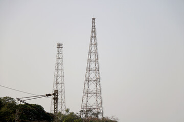 Telecommunication towers with no TV antennas and satellite dish on clear blue sky