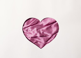 Heart from silk on a white background. Flat lay. Minimal love concept ideas for Valentine's Day
