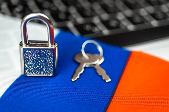 Russia cyber security concept. Padlock on computer keyboard and Russian flag. Close-up view photo