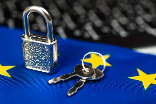 Europe cyber security concept. Padlock on computer keyboard and EU flag. Close-up view photo