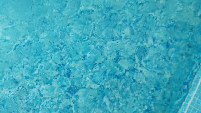 Water drop in swimming pool. Blue color. Stop motion video. H2O hotel relax. Sea wave summer texture. Crystal wet waves. Float calm splash. Nobody liquid background