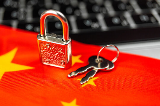 China cyber security concept. Padlock on computer keyboard and China flag. Close-up view photo