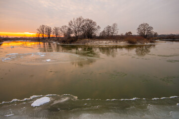 The river is covered with ice, ice floes are floating, winter,element, dawn, sunset, freezing, the power of nature, global warming, flood, floodspring, March, April
