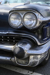 The headlights of an American veteran car.