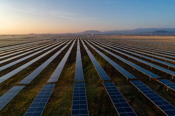 sunrise on solar panel field aerial view