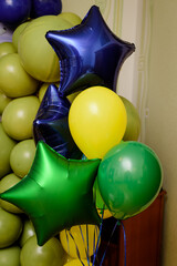 Bunch of blue, green and yellow  party balloons