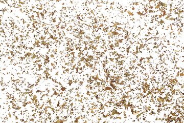 Dried and chopped basil spice pile isolated on white background and texture, top view