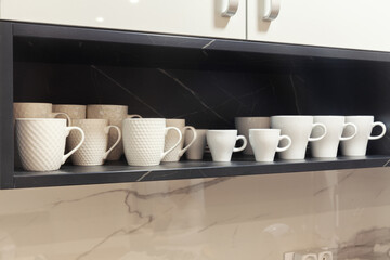 Fototapeta na wymiar white coffee cups on a wooden shelf