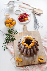 Fruitcake and raisins on a kitchen table. Homemade cupcake with fresh berries on a white table. High quality photo
