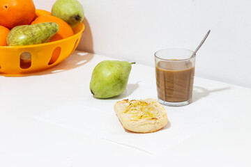Breakfast of toasted bread with extra virgin olive oil, pear and coffee with milk, healthy food concept