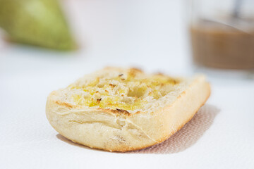 Breakfast of toasted bread with extra virgin olive oil, pear and coffee with milk, healthy food concept