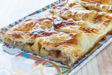 Delicious homemade puff pastry pie stuffed with apple and cinnamon, concept of a healthy lactose-free dessert