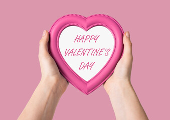 Hands holding heart with happy Valentines day greeting. High quality photo