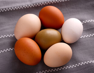 Organic eggs in a towel kitchen on blue table