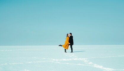 Happy walking couple. In love man and woman walking on the snowy ice. Winter vacation concept....
