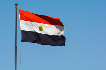 Fototapeta na wymiar Flag of Egypt against clear blue sky