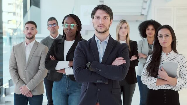 Video of successful business multiage team posing and looking at camera in modern startup.