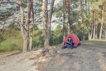 Photographer in nature photographs the landscape of the forest.