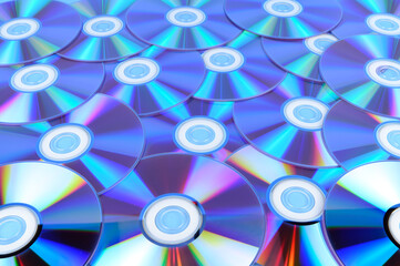 Several CDs are laid out on a horizontal surface