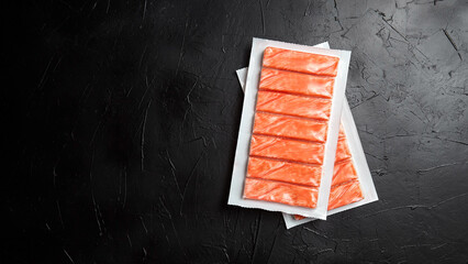 Crab sticks or imitation crab meat on black table top view © mikeosphoto