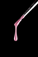 a drop of paint dripping from a brush. nail polish. pink paint