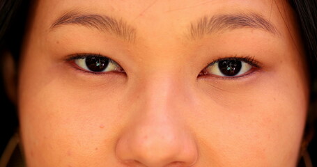 Asian eyes macro close-up, Japanese descent woman staring to camera