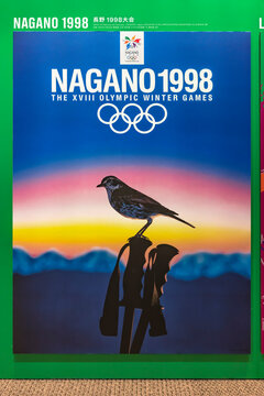 tokyo, japan - august 10 2021: Japanese poster of Nagano 1998 winter olympics games depicting a thrush perched on a ski pole with mountains in the light of dawn evoking the harmony with nature.