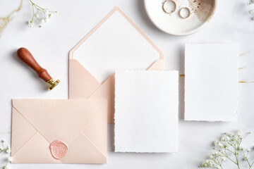 Wedding stationery set. Pastel pink wedding envelopes with wax seal stamp, wedding invitation card,...