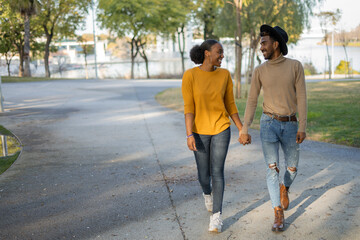 afro couple walking in the park