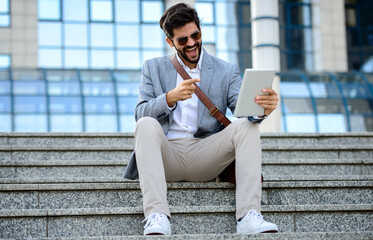 Good news from the client. Happy businessman received a confirmation mail about money transfer via...