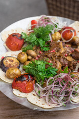 Chargrilled Lamb or Beef Meat and Vegetables Garnished with Red Onion, Fresh Herbs and Pomegranate Seeds