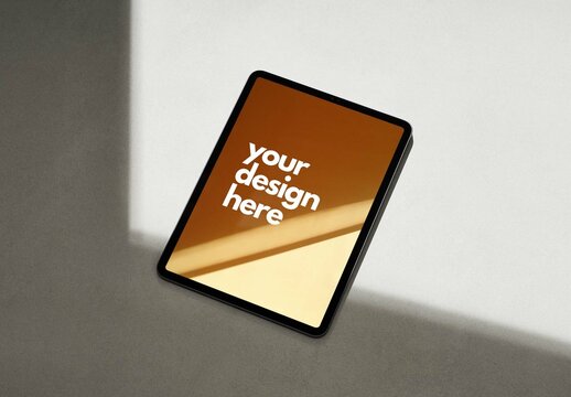Tablet Mockup on a Concrete Surface with Sun Light and Shadows