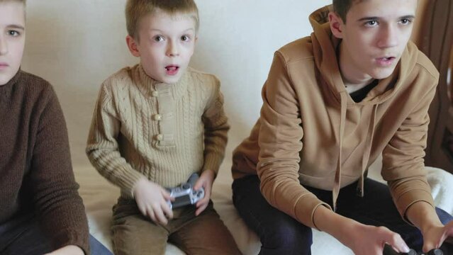 children playing on the console with joysticks in ruhs close-up